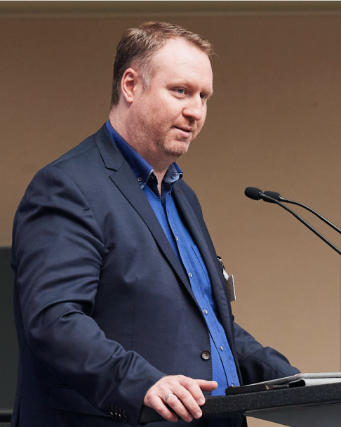 Sebastian Schulze, Referent der Stadt Kaiserslautern, hält auf der 6. NaKoMo-Jahreskonferenz einen Vortrag über Systeme zur Evaluation von Projekten und Maßnahmen im Verkehr.